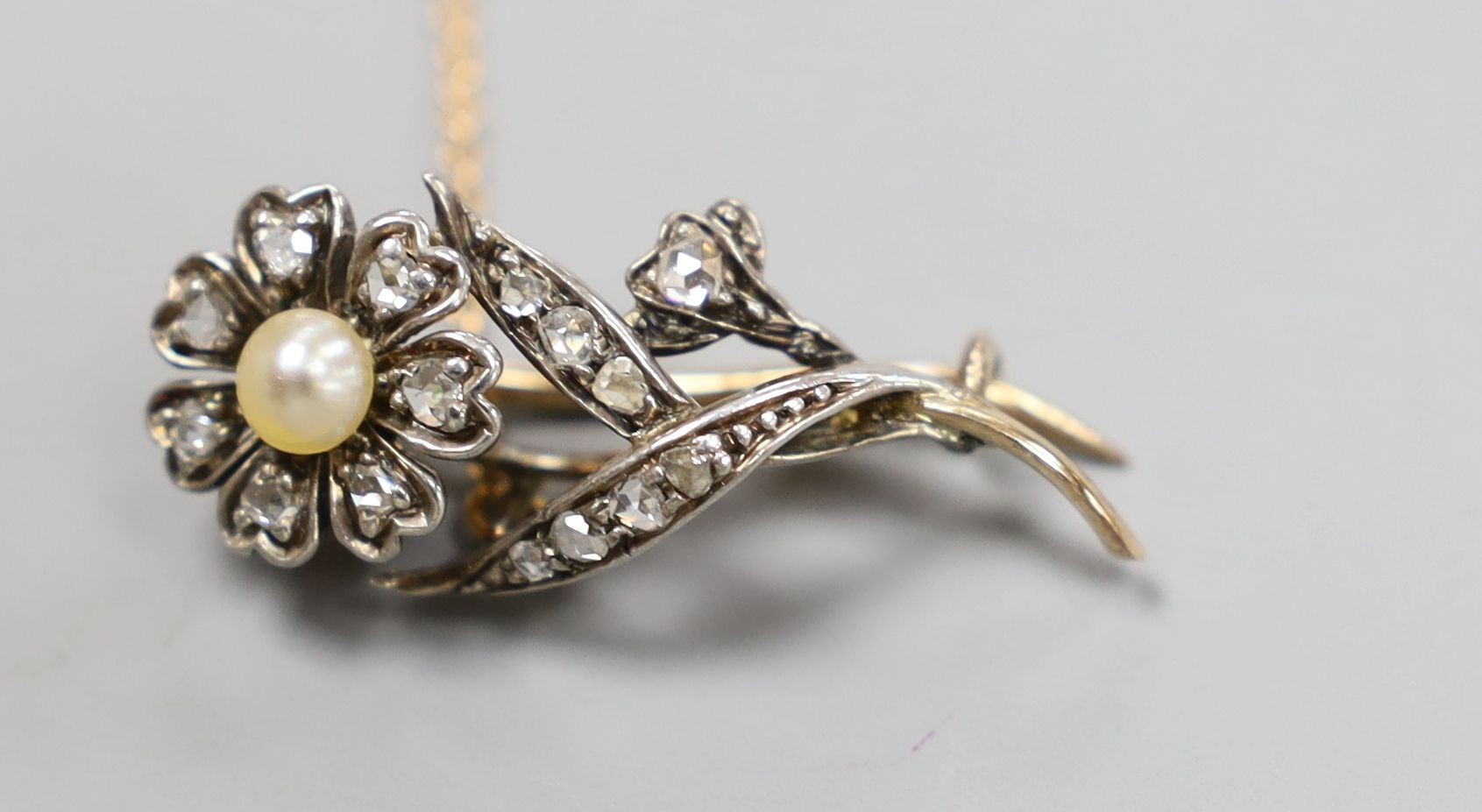 A Victorian yellow metal, pearl and rose cut diamond set flower brooch, 31mm, gross 3.6 grams.